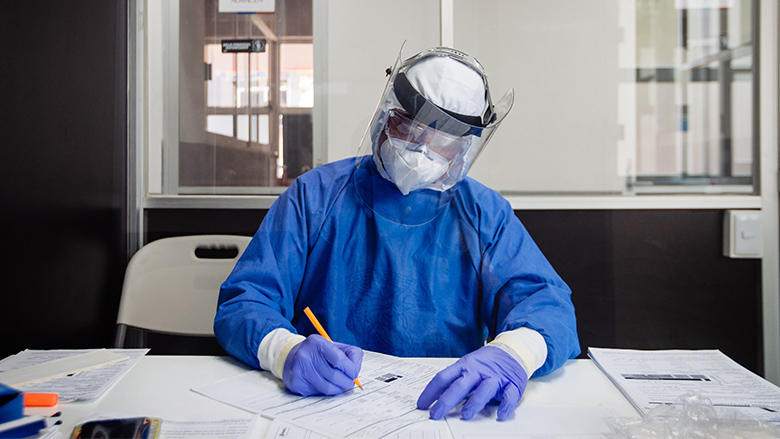 طبيب كيمياء مكسيكي يملأ ورقة عمل قبل إجراء اختبار للفم والأنف بفيروس كورونا Covid19